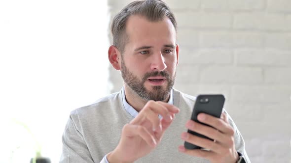 Portrait of Smiling Young Architect Talking on Smartphone