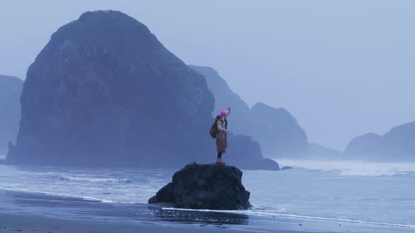 Tourist at Rocky Cliffs Island Background on Rainy Day Slow Motion Happy Travel