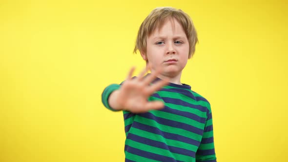 Blond Cute Kid Gesturing No Looking at Camera