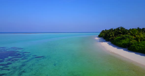 Wide angle drone abstract view of a white paradise beach and blue ocean background in vibrant 