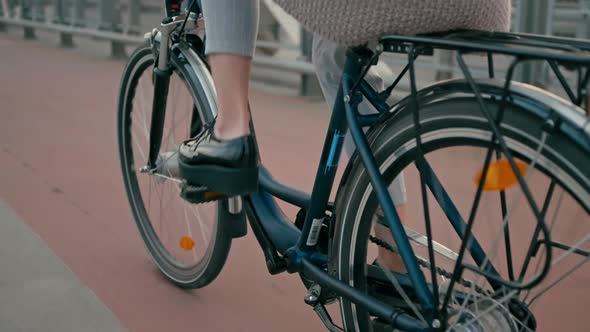 Close Up Female Feet in Shoes Cycling in City on Bridge in the Autumn Morning