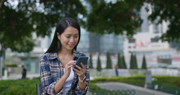 Woman look at mobile phone in city