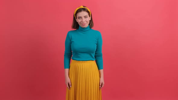 Pretty Girl Looking at Camera with a Smile Isolated Over Red Background