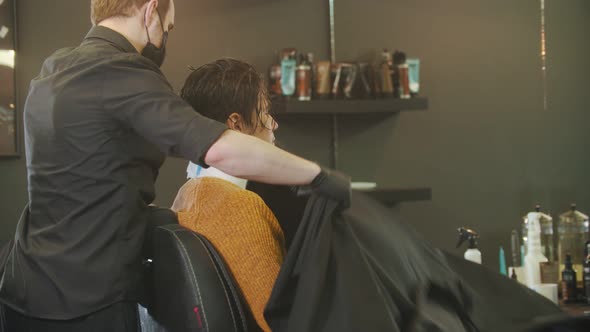 Barber Putting on a Milcoop on His Client in Barbershop