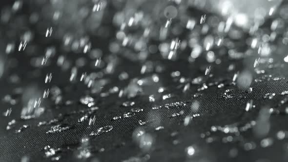 Super Slow Motion Shot of Water Droplets Splashing on Waterproof Cloth at 1000Fps.