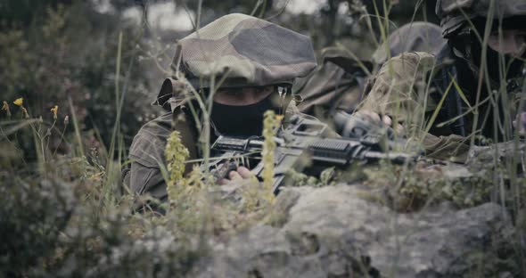 Israeli soldiers in a surveillance and reconnaissance mission using binoculars