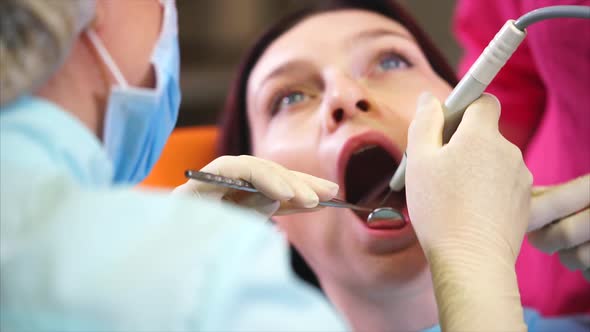 Woman Undergoing Teeth Polishing in Dental Office