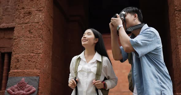 Couple takes a photo and visits ancient temple