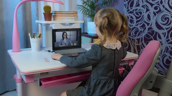 Preschool Child Girl Distance Online Education at Home Pupil Watching Video Lessons on Laptop