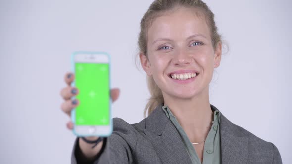 Face of Young Happy Blonde Businesswoman Showing Phone