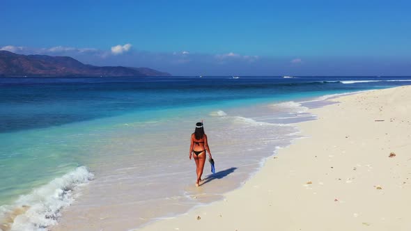 Women posing on idyllic lagoon beach adventure by turquoise lagoon with white sandy background of Gi