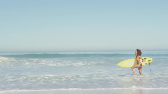 African American woman ready to go surf