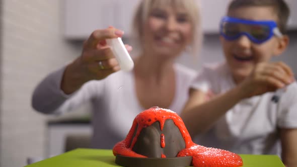 Close Up Hands Pouring Water To Achieve Eruption