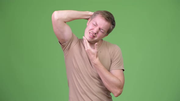 Young Tired Scandinavian Man Having Neck Pain