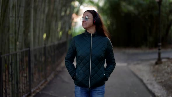 Portrait of a European Woman Listening to Music and Dancing in the Park