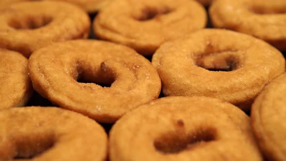 A lot of doughnuts in on the black desk