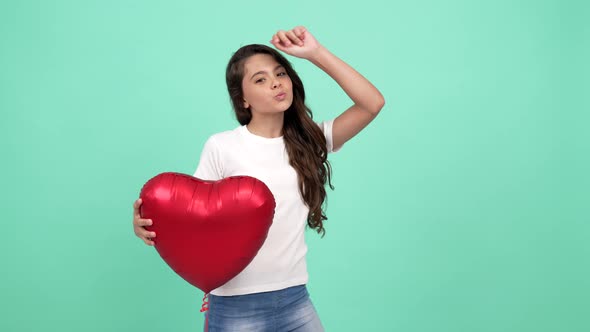 Portrait of Happy Kid Dancing with Red Heart Party Balloon Showing Peace Gesture Fun