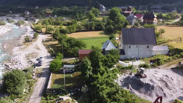 Flying Near Old Wooden Church and Trees in Thethi Valley Albania