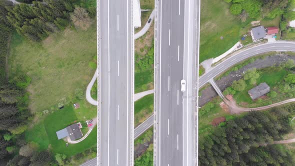 Aerial Top View of Highway Viaduct with Multilane Traffic in Mountains. Autobahn in Austria