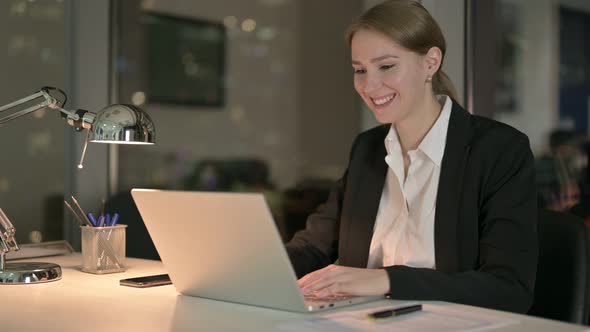 Ambitious Businesswoman Doing Video Chat on Laptop at Night 