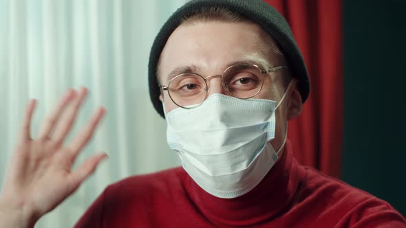 Closeup Face of Cheerful Young Man in Protective Mask Wearing Glasses Hat