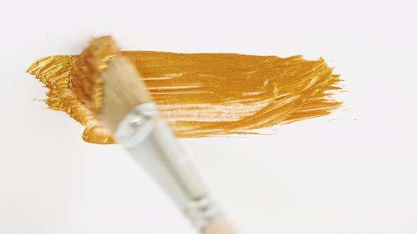 Abstract Brushstrokes of Gold Paint Brush Applied Isolated on a White Background