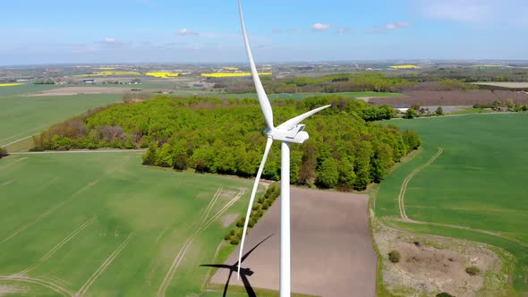 Drone circling around windmill with beautiful view of landscape