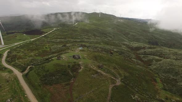 Windmills or Wind Turbine in Morning Fog