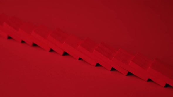 Red Dominoes Falling in Chain Reaction