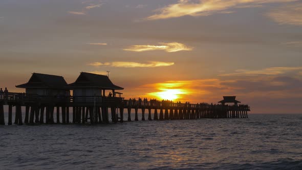Silhouette of a Pier Over the Water at Sunset, 