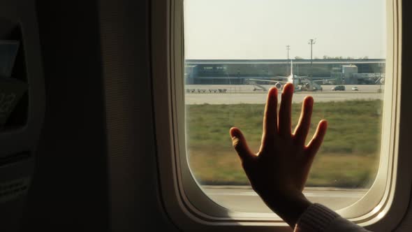 Kid s Hand Touching Airplane Window Close Up