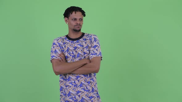 Angry Young African Man Looking Stressed with Arms Crossed