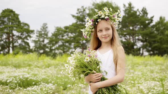 Smiling Girl in Floral Wreath with Chamomile Bouquet Summer Field, Portrait Girl Teenager