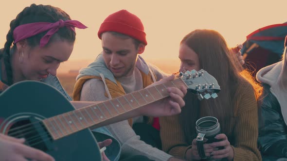 Couple Covers with Plaid Spending Time with Friends in Camp