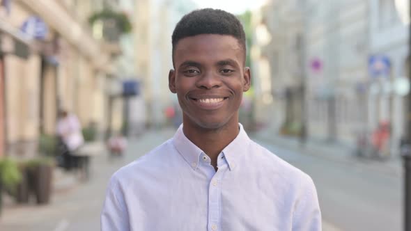 Portrait of Happy African Man Smiling Toward the Camera Outdoor