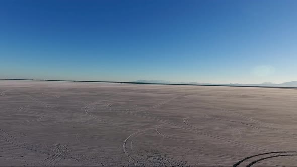 Flying over the Bonneville Salt Flats in Northwestern Utah reveals I-80 in the background and tire t