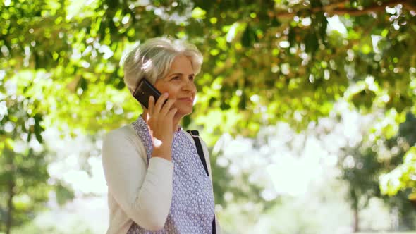 Senior Woman Calling on Smartphone in Park 7