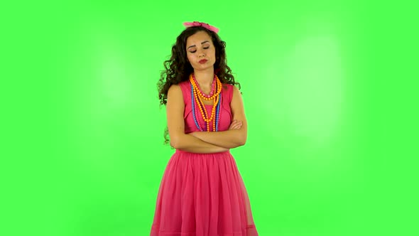 Young Woman Stands Waiting with Boredom on Green Screen