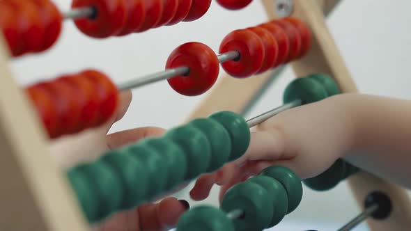 Child Plays with a Multicolored Toy 9 Mom Helps