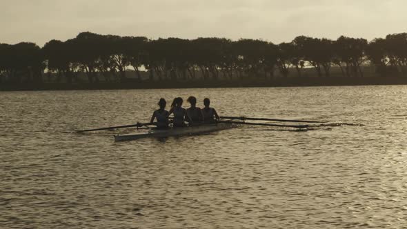 Female rowing team training on a river