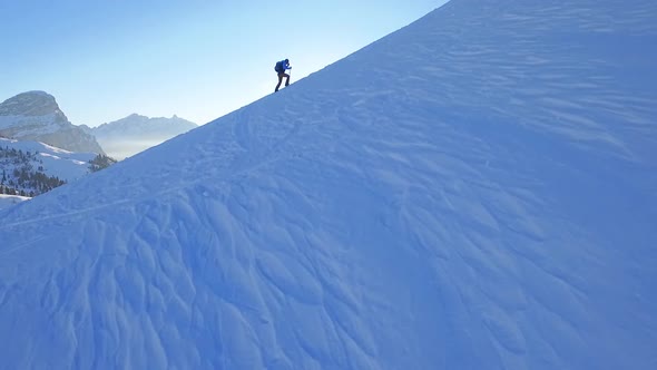 Man snowshoeing in the dolomites at sunrise