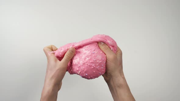 Close-up Top View: Pink Slime Sticks To the Hands, Then Hands Stretch the Slime