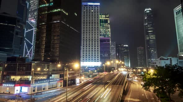 Hong Kong City Traffic After Sunset. Illuminated Street and Skyscrapers in Hong Kong at Night