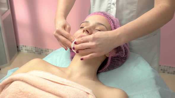 Hands of Cosmetician Wiping Skin