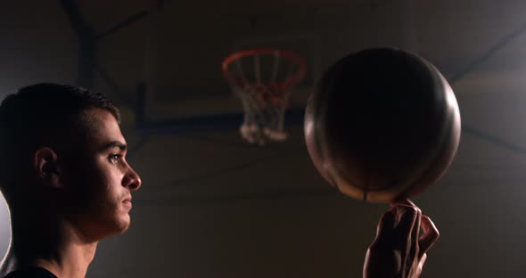 Sportsman spinning basketball on finger