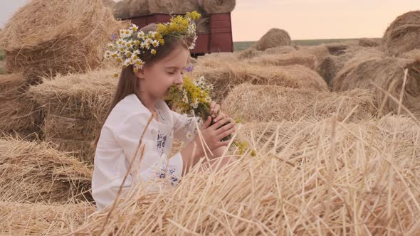 Girl Sitting on Hay