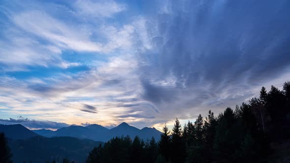 Golden clouds over the landscape at dusk. The last rays of the sun