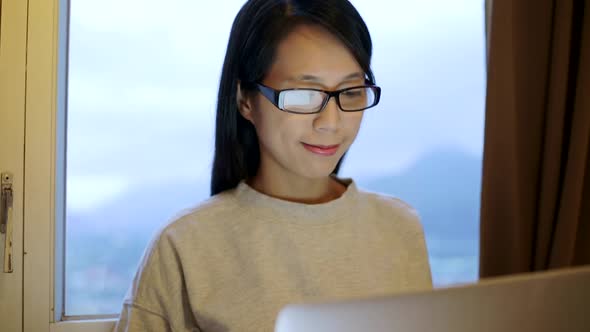 Woman working on laptop computer at home