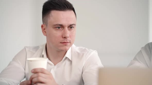 Closeup of Colleague Working with Businessman Office Manager. Drink From Cup and Listen Discuss