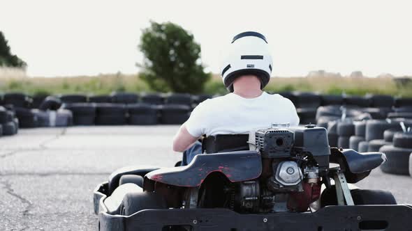 Male Racer in Protective Helmet Racing on the Go-kart Track Outdoors